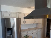 Here is a view of the fridge in it's new location.  I also built a wider over fridge cabinet and extended the soffit to match the width of the new fridge.