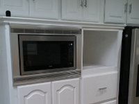 Here is the same cabinet area with new microwave and 2 custom drawers that have replaced the very small wall oven.  Drawers provide storage lost when the cabinet under the cook top was modified to receive the new 30" convection oven.  Area above new drawers will also have custom doors made and installed by us.