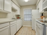 Here is a view of the remodeled galley kitchen.  We repaired and refinished the existing cabinets.  We also installed the flourescent lighting, and installed the custom 2" blinds.  Low cost remodel but alot of bang for the buck!