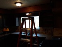 Here is what the sink are looked like before.  Soffit over the window and cabinets on each side of the window made the kitchen really cramped.  Also, over mount sink and formica counter tops were very outdated.